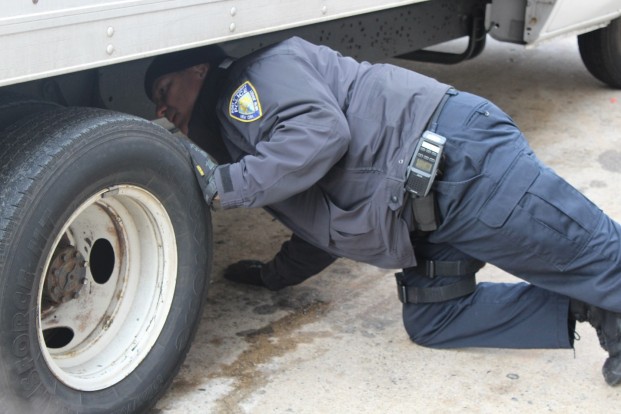 PAPD CVI Walter Franco inspecting a commercial vehicle